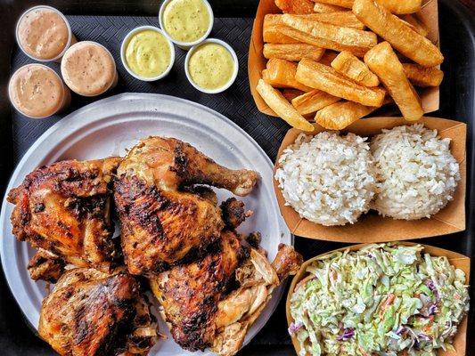 Whole chicken meal with yucca fries, slaw and garlic rice.