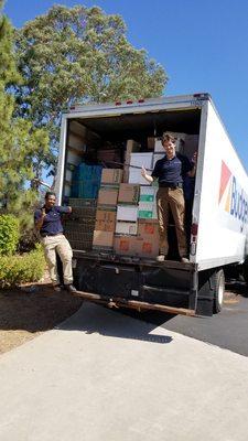 Super hard workers who packed our truck. It's filled floor-to-ceiling and front-to-back!