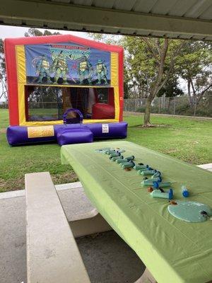 Teenage Mutant Ninja Turtle bounce house. The banner choice led to the party's theme.