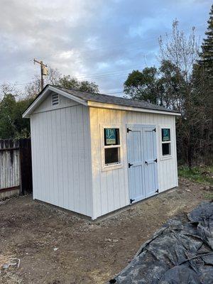 8x12 shed with some custom items like an overhang and black hardware.