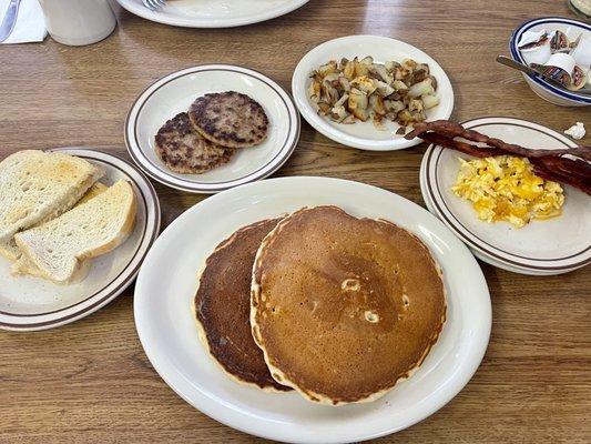 1 Egg with Bacon, short stack, home fries, sausage patties with sourdough bread