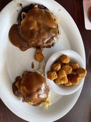 Sirloin chopped steak with brown gravy and onions, mashed potatoes and fried okra