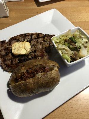 Steak special. With sausage and cabbage (it was good, my first time) and a loaded potato.