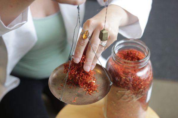 We use a traditional Asian scale to weigh out herbs. Here we are weighing out Safflower 红花 for a formula to increase blood circulation.