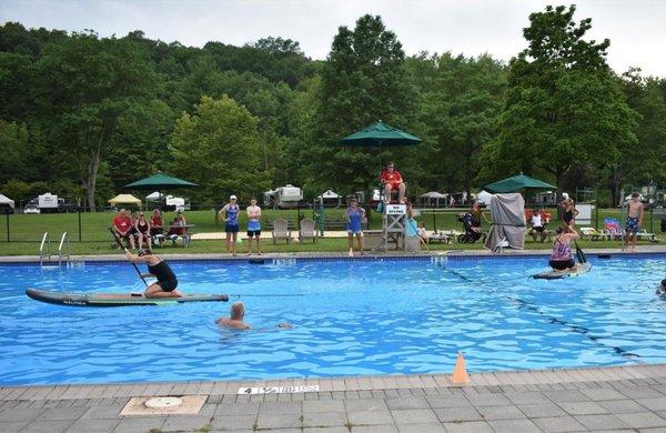 Paddle board tug-of-war event in the pool.