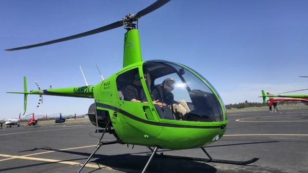 Robinson R22 helicopter, in signature Leading Edge green.