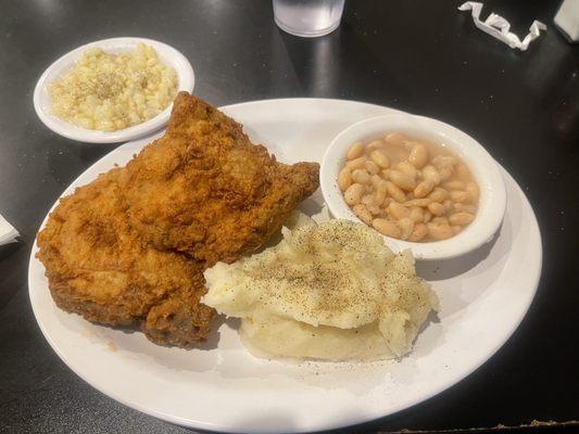 Pork chops, creamed potatoes, white beans, and fried corn.