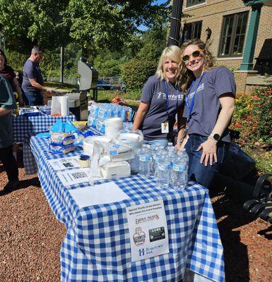 Staff members handing out free lunch at our community picnic.