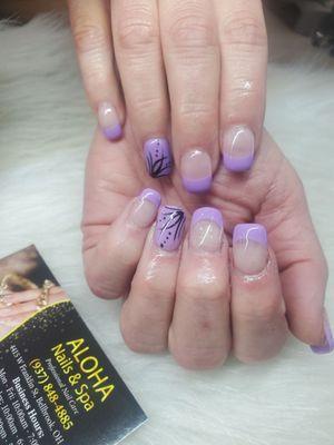 Acrylic nails with Purple tips and a cute design.