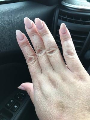 Acrylic almond-shaped nails with nude pink gel polish. Nails by Andy Nguyen.