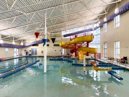 The indoor water park with zero depth entry, water channel, lap swimming, and water slide.