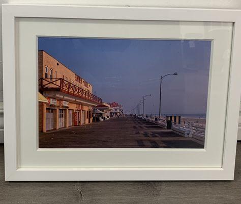 Old photo of Coney Island with a thick matting and a classic white frame.