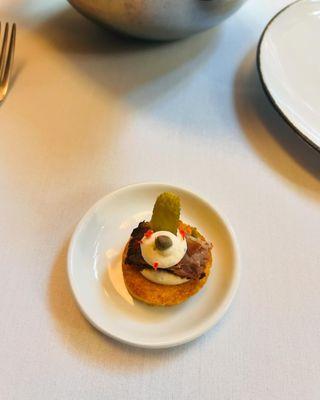 Amuse Bouche (short rib with cornichon) on a crouton like cracker