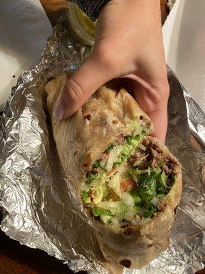 Steak burrito fully dressed (lettuce, cheese, tomato, cilantro, avocado)