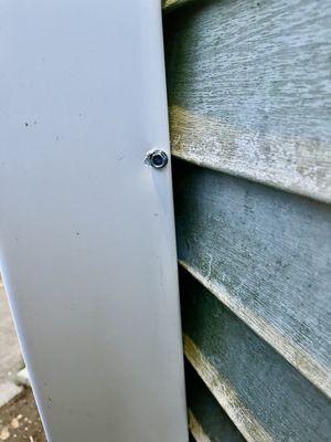 Hole in privacy fence .