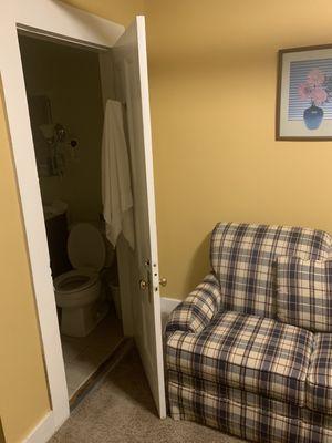 This is loveseat blocking the bathroom door.