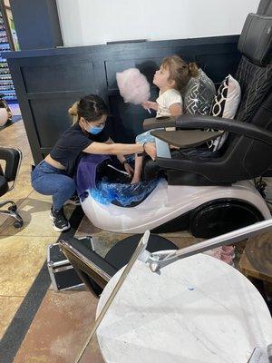 Tee getting my daughter set up for her mani pedi--she even got a huge cotton candy! This place ROCKS