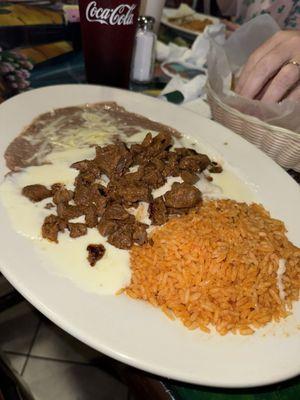 Cheese enchiladas topped with steak and Queso