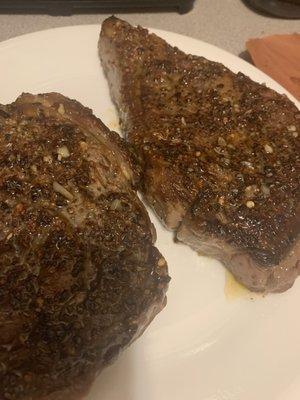 Ribeye steaks with their homemade steak seasoning and garlic butter