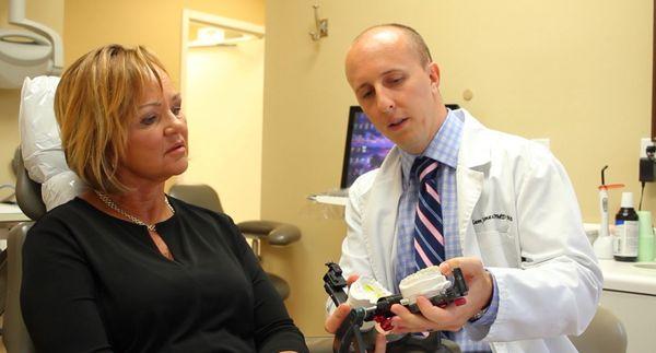 Dr. Adam Jones educating his dental patient