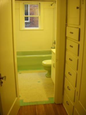 built in dresser in walk-through closet, original bath tiles and tub