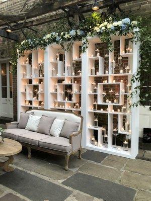 Stunning lounge area with a candle wall backdrop.