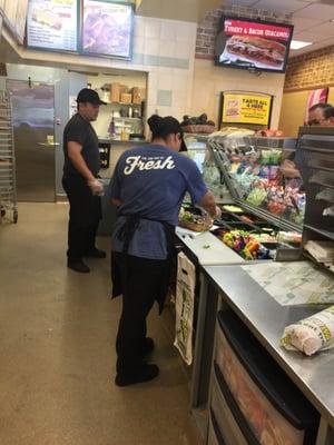 This lady and gentleman working hard getting my sandwiches done quickly. Thank you staff.