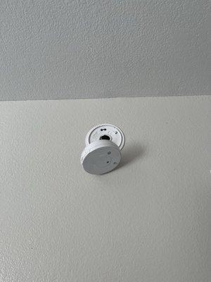 Smoke detector hanging on for dear life.