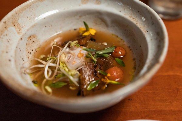 Canh Chua - Roasted Cod, tamarind fumet, cured beansprouts, charred pineapple, blistered tomato, taro stem, rice paddy herb, crispy garlic