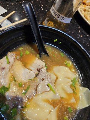 Bowl of dumplings with that special bottle of vinegar.