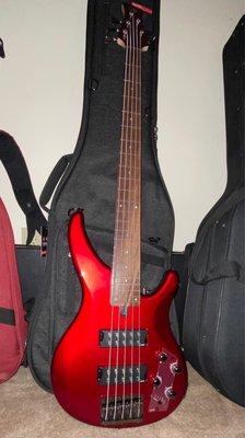 Yamaha TRBX305 in Candy Apple Red with Gator case behind