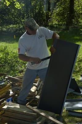 Indianapolis Roofer Jim Farmer preps a metal panel for installation on a standing seam metal roof.