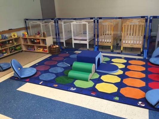 Our young infant room where babies have space to explore, play, and be nurtured by loving caregivers.