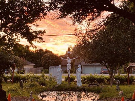 The cross in front of the pond in the church garden