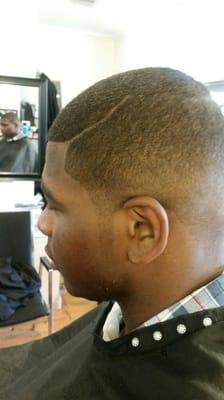 This is a low medium fade with long side burns with a long part