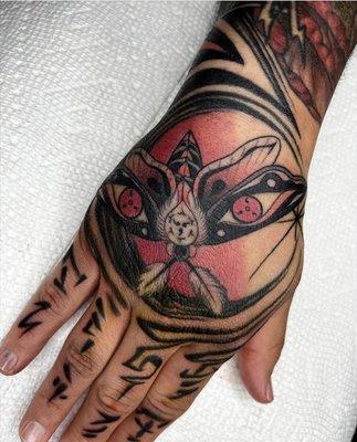 Moth hand tattoo