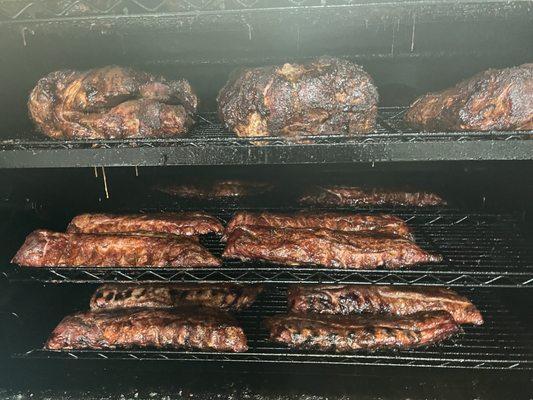 A picture of our delicious smoked baby back pork ribs, and pork butts