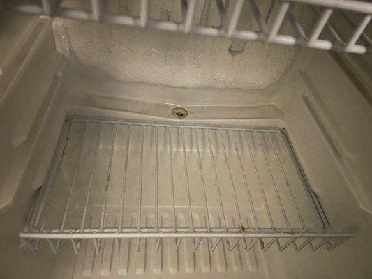 Dirt inside the mini fridge.