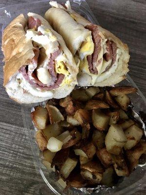 Pork roll, fried egg & cheese on a long roll with a side of home fries with onions