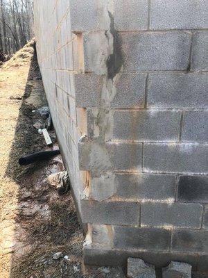 Kevin McGhee/ McGhee Construction did this all this they tried to patch wall where it's blowing out due to poor drainage systems