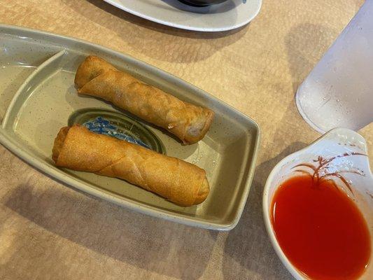 Egg rolls in a cute little boat and sweet and sour sauce