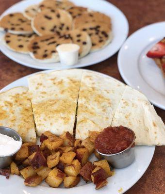 Vegan quesadilla- stuffed with veggies, avocado, vegan cheese, and comes with sides of vegan sour cream, salsa and potatoes