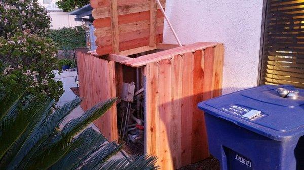 Pool equipment redwood  cover with lid and rolling gate with metal frame.