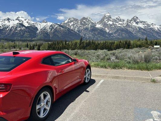 Red Camaro in front of the Grand Tetons