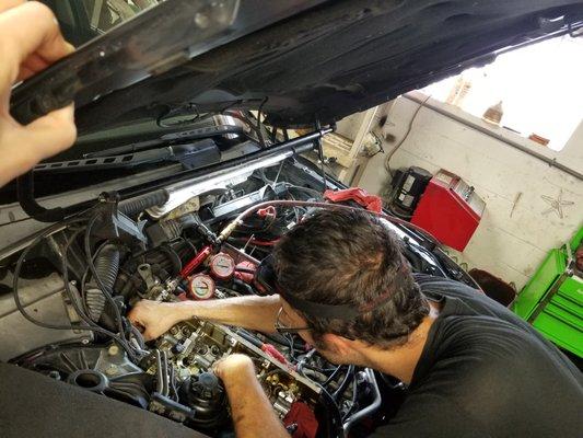 One of the mechanics replacing valve seals off of a a 2004 545iGT BMW.