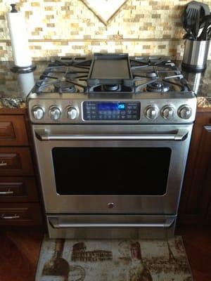 GE cafe with 4 burner and grill, 2 ovens.