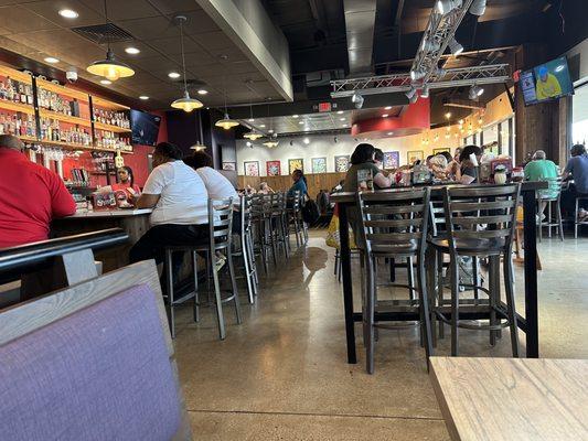 Bar atmosphere with high top tables and booths