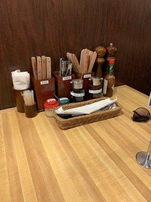 All the utensils and condiments you need right at the table. Chopsticks and spoons are in the basket under the paper towel