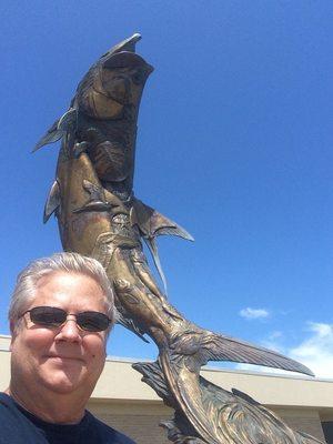 Fantastic bronze sculpture in front of a tarpon that is indigenous to this area