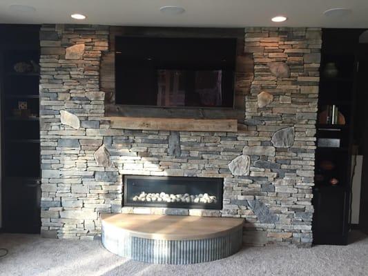 Fireplace done in Echo Ridge Country Ledgestone by Boral Cultured Stone with custom wood mantel and limestone hearth.